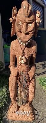Antique Carved Papua New Guinea Cowrie Eyed Chief Wearing A Lizard Head Dress