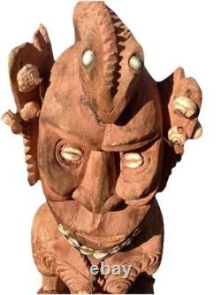 Antique Carved Papua New Guinea Cowrie Eyed Chief Wearing A Lizard Head Dress