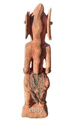 Antique Carved Papua New Guinea Cowrie Eyed Chief Wearing A Lizard Head Dress