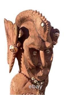Antique Carved Papua New Guinea Cowrie Eyed Chief Wearing A Lizard Head Dress