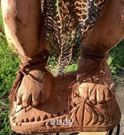 Antique Carved Papua New Guinea Cowrie Eyed Chief Wearing A Lizard Head Dress