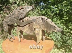 Metal sculpture of mating pigs from Papua New Guinea
