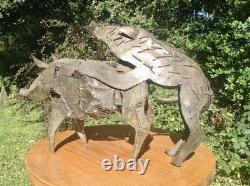 Metal sculpture of mating pigs from Papua New Guinea