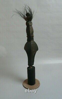 Papua New Guinea Sepik ancestor figure with cowrie shell and feather decorations