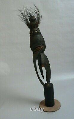 Papua New Guinea Sepik ancestor figure with cowrie shell and feather decorations