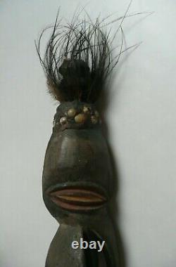 Papua New Guinea Sepik ancestor figure with cowrie shell and feather decorations