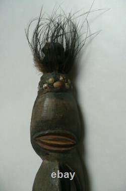 Papua New Guinea Sepik ancestor figure with cowrie shell and feather decorations Papua New Guinea Sepik ancestor figure with cowrie shell and feather decorations