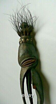 Papua New Guinea Sepik ancestor figure with cowrie shell and feather decorations