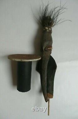 Papua New Guinea Sepik ancestor figure with cowrie shell and feather decorations